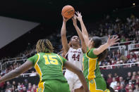 Stanford forward Kiki Iriafen (44) shoots over Oregon's Sarah Rambus (23) and Phillipina Kyei (15) during the second half of an NCAA college basketball game Friday, Jan. 19, 2024, in Stanford, Calif. (AP Photo/Tony Avelar)