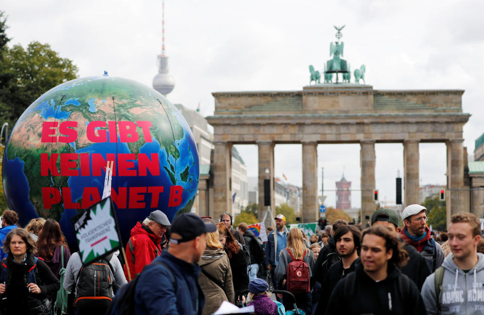 People gather in front of the Brandenburg Gate to take part in the Global Climate Strike of the movement Fridays for Future, in Berlin, Germany, September 20, 2019. The inflatable globe reads: "There is no planet B". REUTERS/Fabrizio Bensch