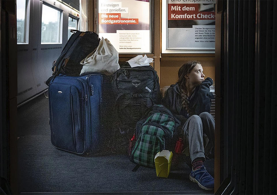In this image taken from Twitter feed of Climate activist Greta Thunberg, showing Thunberg sitting on the floor of a train surrounded by bags Saturday Dec. 14, 2019, with the comment “traveling on overcrowded trains through Germany. And I’m finally on my way home!” The Tweet created a tweetstorm online Sunday about the performance of German railways, but the 16-year-old Swedish activist later sought to draw a line under the matter by tweeting that she eventually got a seat and that overcrowded trains are a good thing showing public transport is popular. (Twitter @GretaThunberg via AP)
