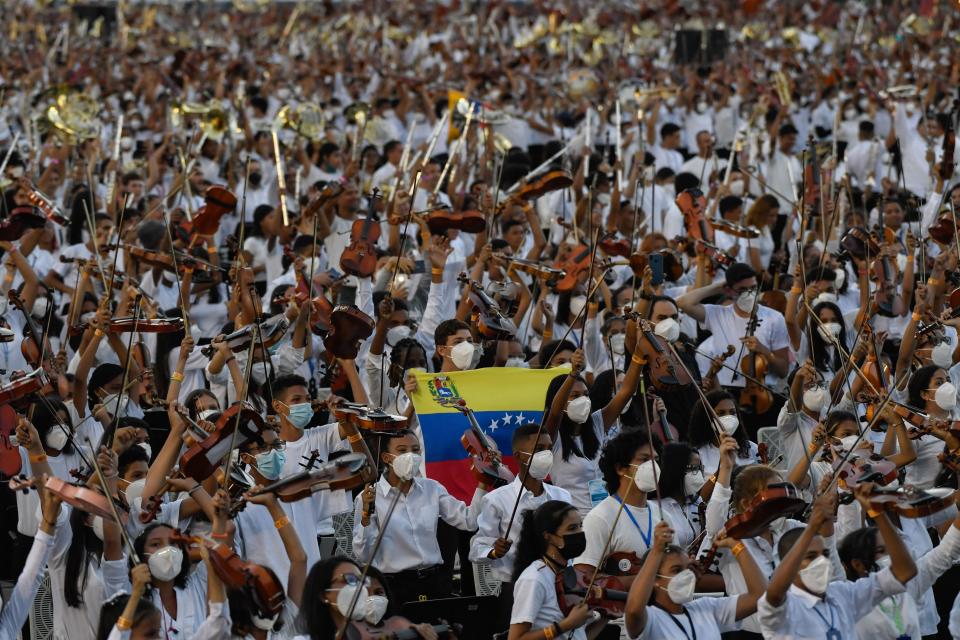 Members of the National System of Orchestras of Venezuela play during an attempt to enter the Guinness Book of Records for the largest orchestra in the world, with more than 12,000 musicians, at the Military Academy of the Bolivarian Army in Fuerte Tiuna Military Complex, in Caracas, on November 13, 2021. (Photo by Federico PARRA / AFP) (Photo by FEDERICO PARRA/AFP via Getty Images)