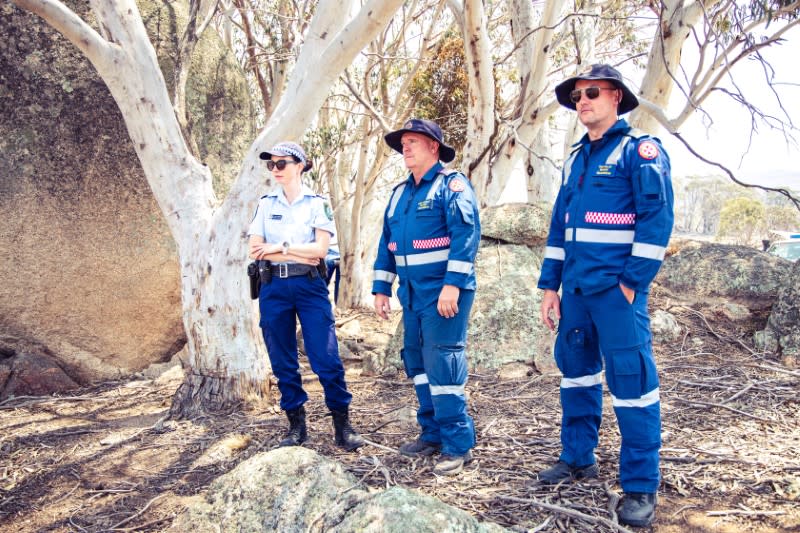 Police and rescue personnel are seen following the crash of a C-130 air tanker plane after dropping fire retardant, in this January 24, 2020 picture obtained from social media