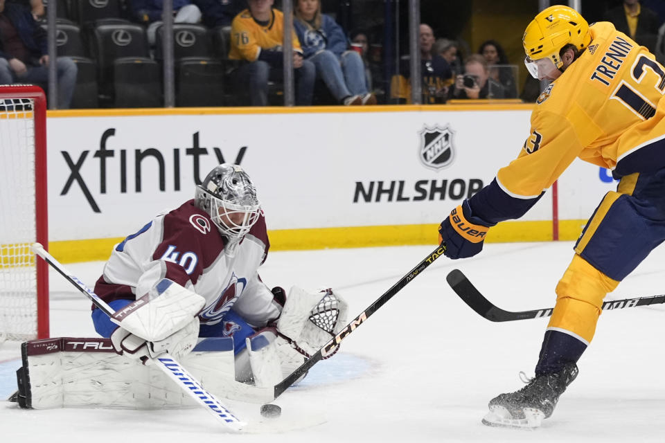 Colorado Avalanche goaltender Alexandar Georgiev (40) blocks a shot on goal by Nashville Predators center Yakov Trenin, right, during the second period of an NHL hockey game Saturday, March 2, 2024, in Nashville, Tenn. (AP Photo/George Walker IV)