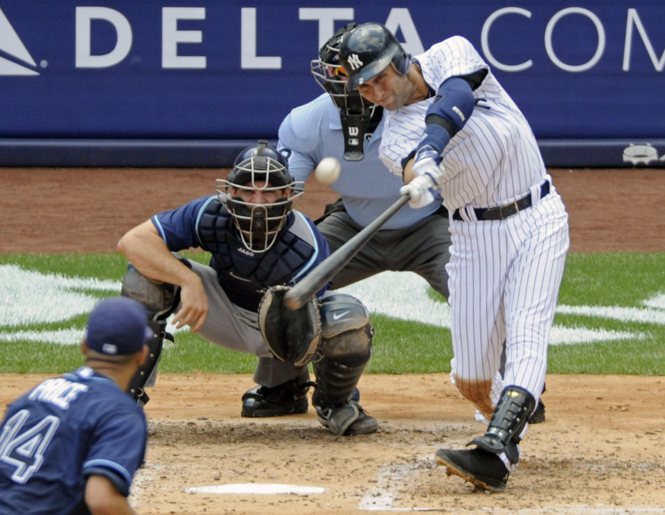 FILE - In this July 9, 2011, file photo, New York Yankees' Derek Jeter hits a home run for his 3,000th career hit during the third inning of a baseball game against the Tampa Bay Rays at Yankee Stadium in New York. Jeter could be a unanimous pick when Baseball Hall of Fame voting is announced Tuesday, Jan. 21, 2020. (AP Photo/Bill Kostroun, File)