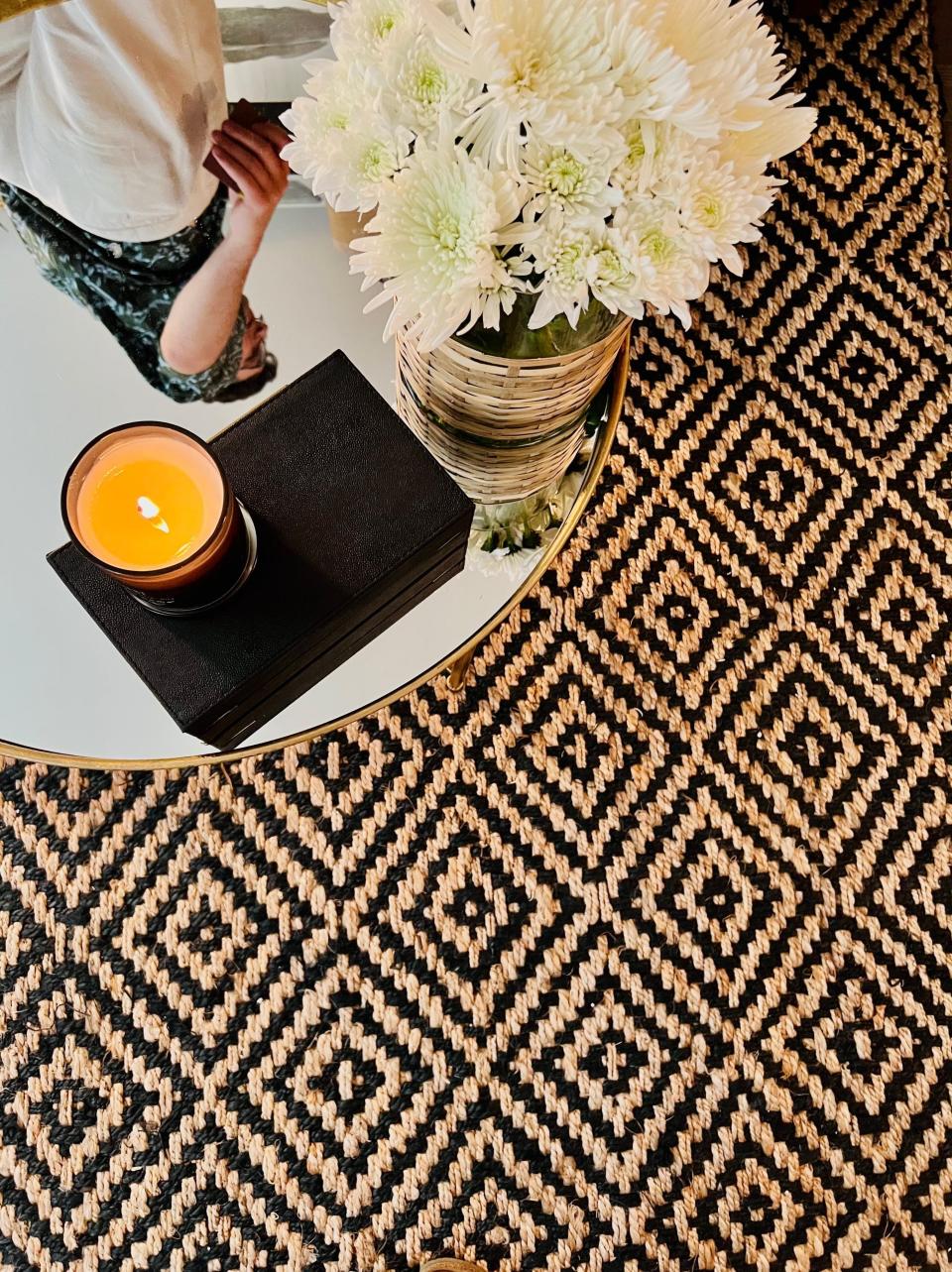 A side table and rug in the apartment redesigned by budget-luxury expert Clare Sullivan.