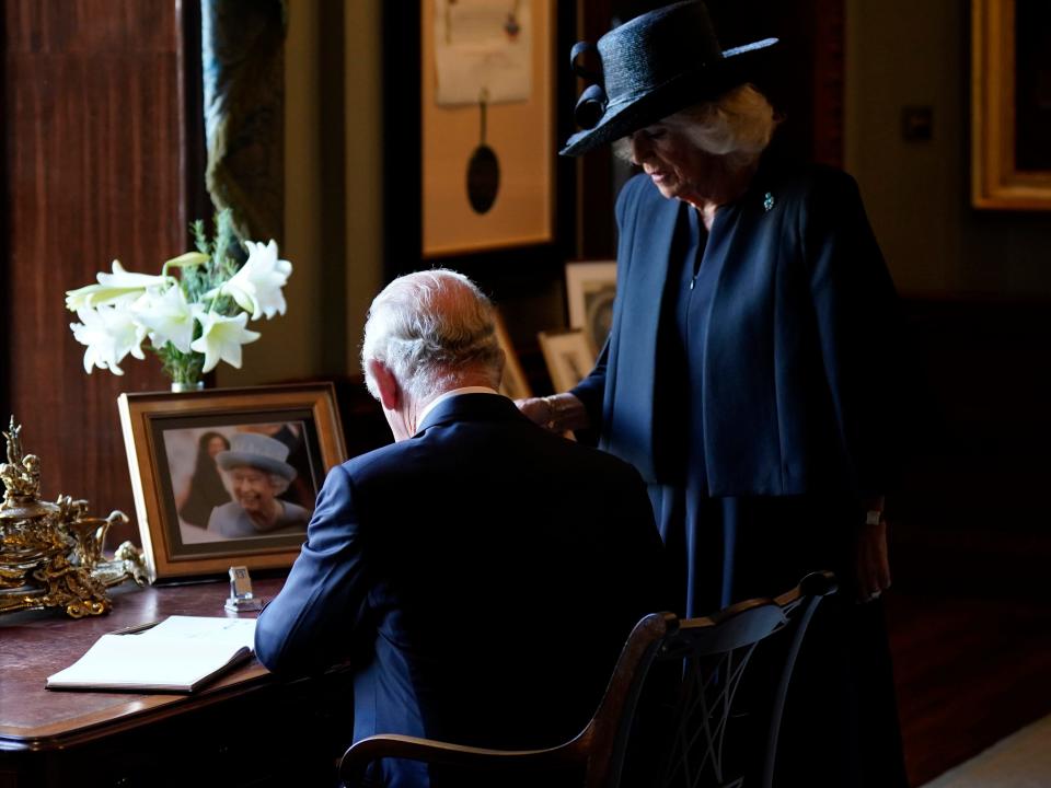 HILLSBOROUGH, NORTHERN IRELAND - SEPTEMBER 13: King Charles III and Camilla, Queen Consort sign the visitors book at Hillsborough Castle on September 13, 2022 in Hillsborough, United Kingdom. King Charles III is visiting Northern Ireland for the first time since ascending to the throne following the death of his mother, Queen Elizabeth II, who died at Balmoral Castle on September 8, 2022. (Photo by Niall Carson - WPA Pool/Getty Images)