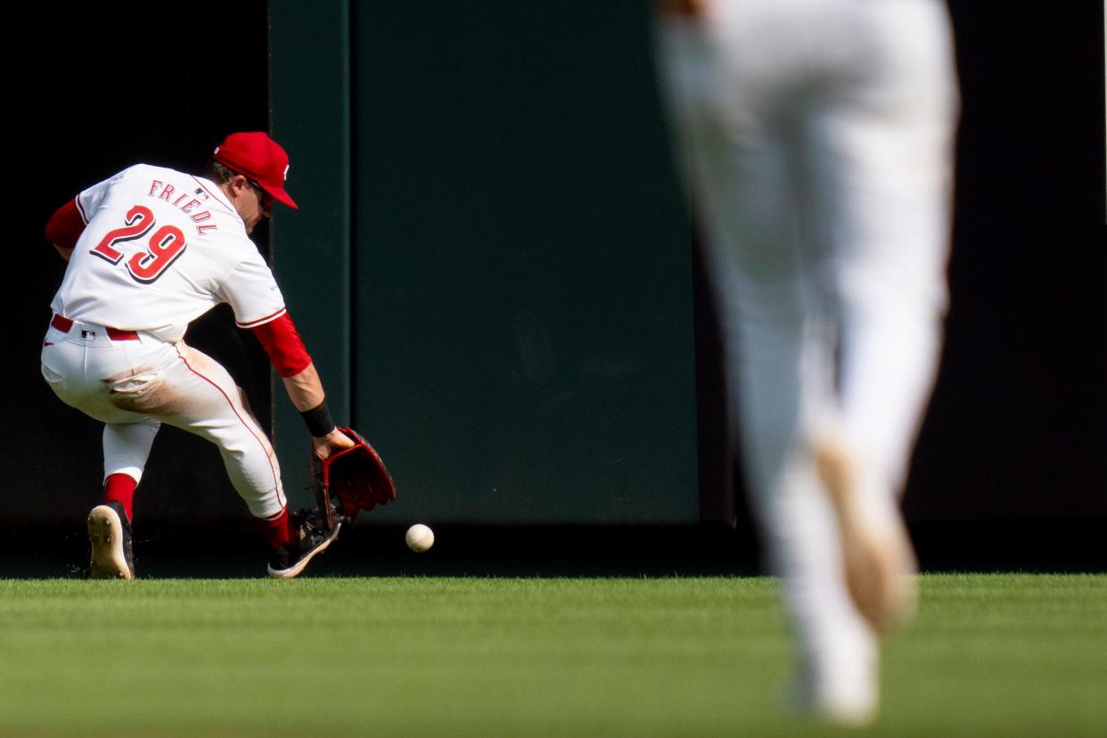 TJ Friedl chases down a hit in Saturday's game against the Red Sox.