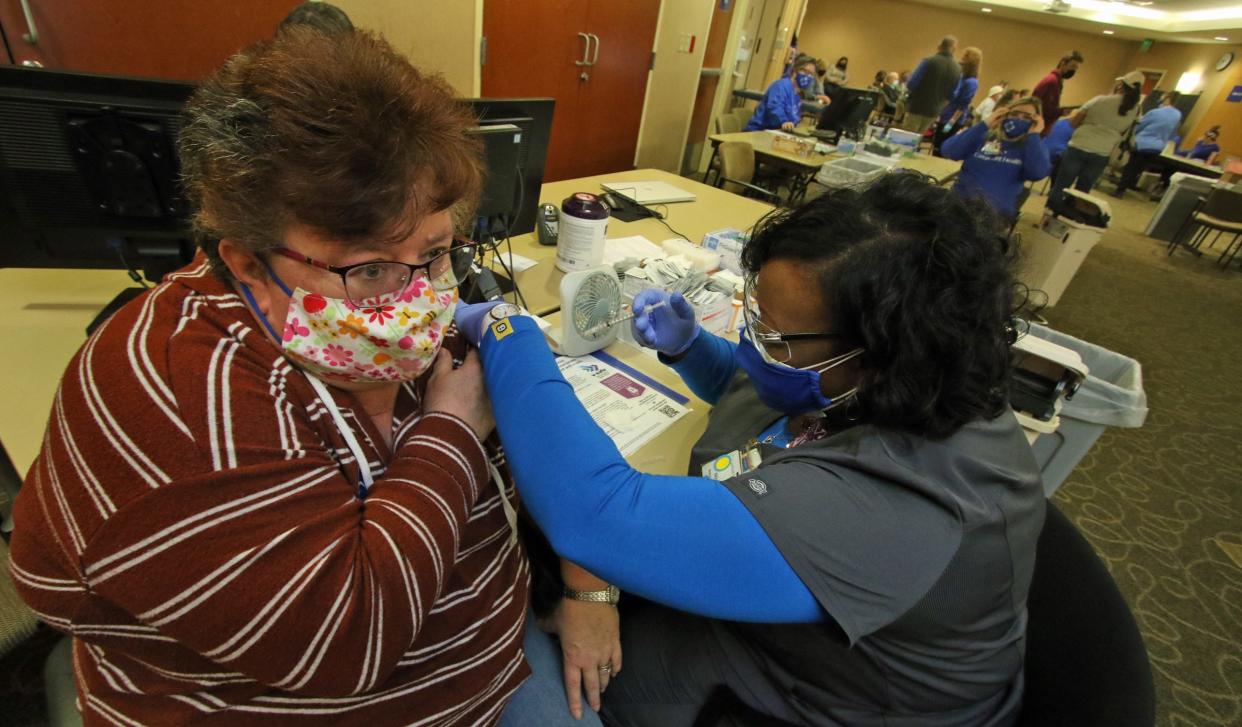 Sadler Elementary School teacher Lori Williams gets her vaccination shot from Nitra Lowery as CaroMont Health hosted a COVID-19 vaccination event for teachers in 2021 at CaroMont Regional Medical Center in Gastonia
