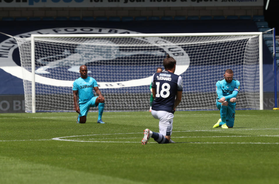 Players in England, like those of Millwall and Derby on Saturday, have been taking the knee at the beginning of games since June. (Jonathan Brady/Getty)