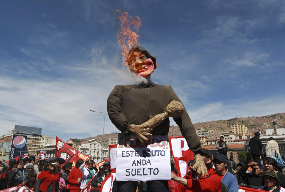 Manifestantes prenden fuego un muñeco que representa al presidente Evo Morales durante una marcha en La Paz, Bolivia, el martes 1 de mayo de 2012. (AP foto/Juan Karita)