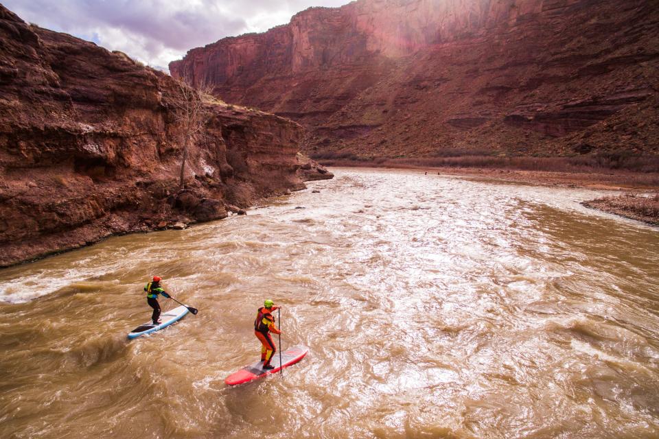 Utah’s rugged landscapes invite adventurous outdoor recreation, such as paddle boarding down the Colorado River in Moab.
