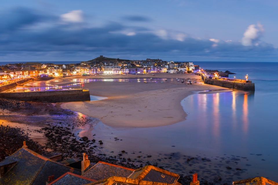 A view overlooking St Ives harbour at dusk (Getty Images/iStockphoto)