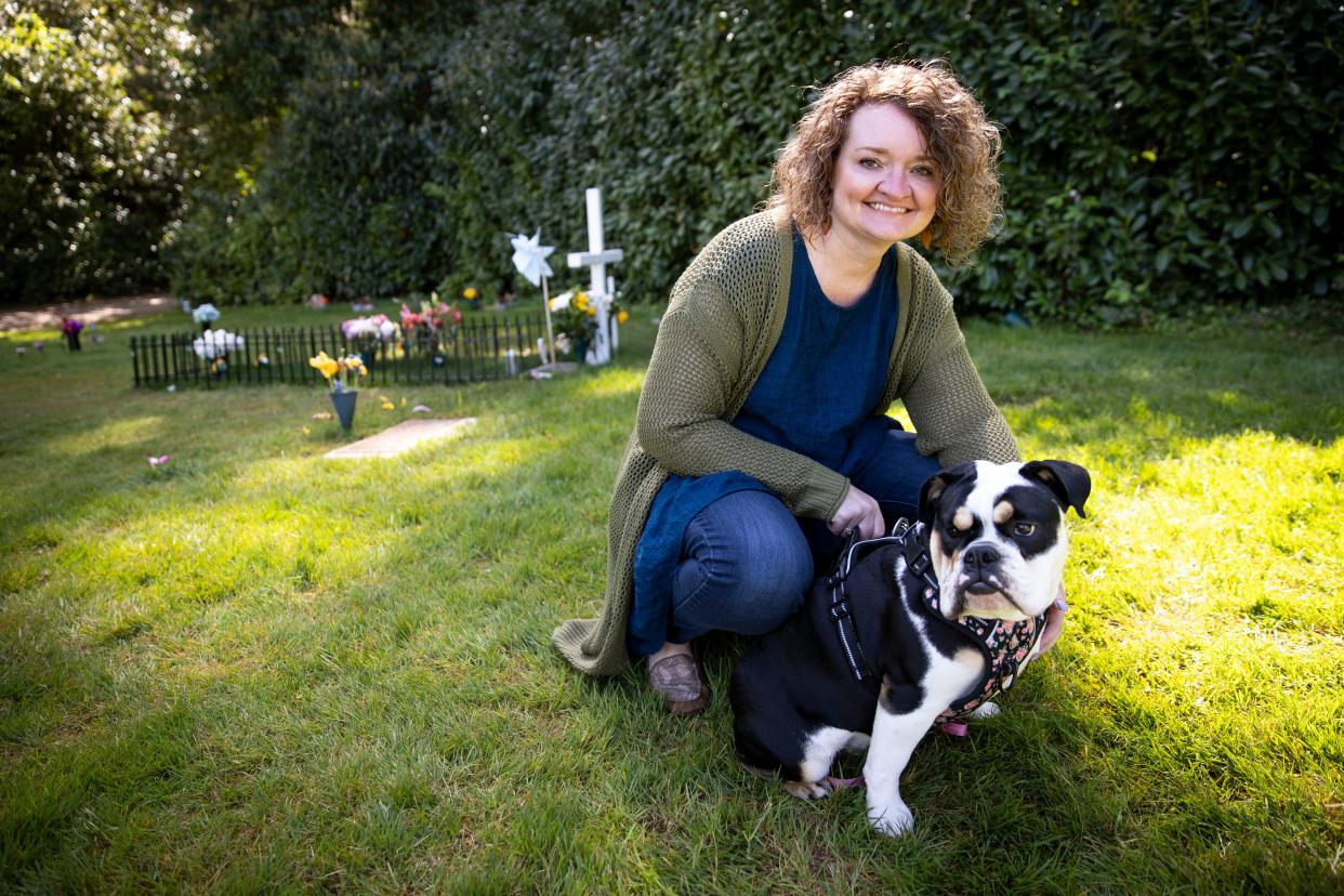 Kym Herring works at Belcrest Memorial Park cemetary in Salem with her English bulldog, Hazel, who has become an emotional support for grieving families.