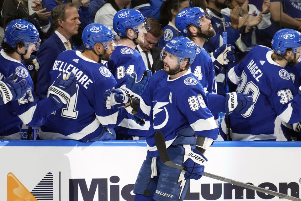 Tampa Bay Lightning right wing Nikita Kucherov (86) celebrates with the bench after his goal against the New Jersey Devils during the first period of an NHL hockey game Sunday, March 19, 2023, in Tampa, Fla. (AP Photo/Chris O'Meara)