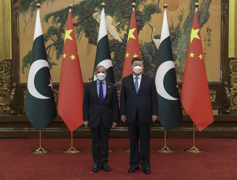 In this photo released by Xinhua News Agency, Chinese President Xi Jinping, right, poses with Pakistani Prime Minister Shahbaz Sharif before their bilateral meeting at the Great Hall of the People in Beijing, Wednesday, Nov. 2, 2022. Xi on Wednesday affirmed his country's commitment to invest in Pakistan despite obstacles created in recent years by security concerns and the global economic slowdown. (Yao Dawei/Xinhua via AP)