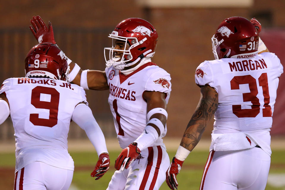 STARKVILLE, MISSISSIPPI - OCTOBER 03: Greg Brooks Jr. #9 of the Arkansas Razorbacks celebrates an interception returned for a touchdown with Jalen Catalon #1 against the Mississippi State Bulldogs during the first half at Davis Wade Stadium on October 03, 2020 in Starkville, Mississippi. (Photo by Jonathan Bachman/Getty Images)