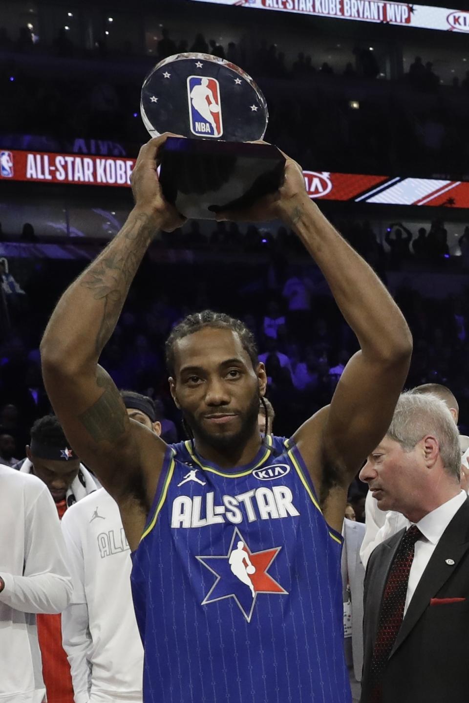 Kawhi Leonard of the Los Angeles Clippers holds up his NBA All-Star Game Kobe Bryant MVP Award after the NBA All-Star basketball game Sunday, Feb. 16, 2020, in Chicago. (AP Photo/Nam Huh)