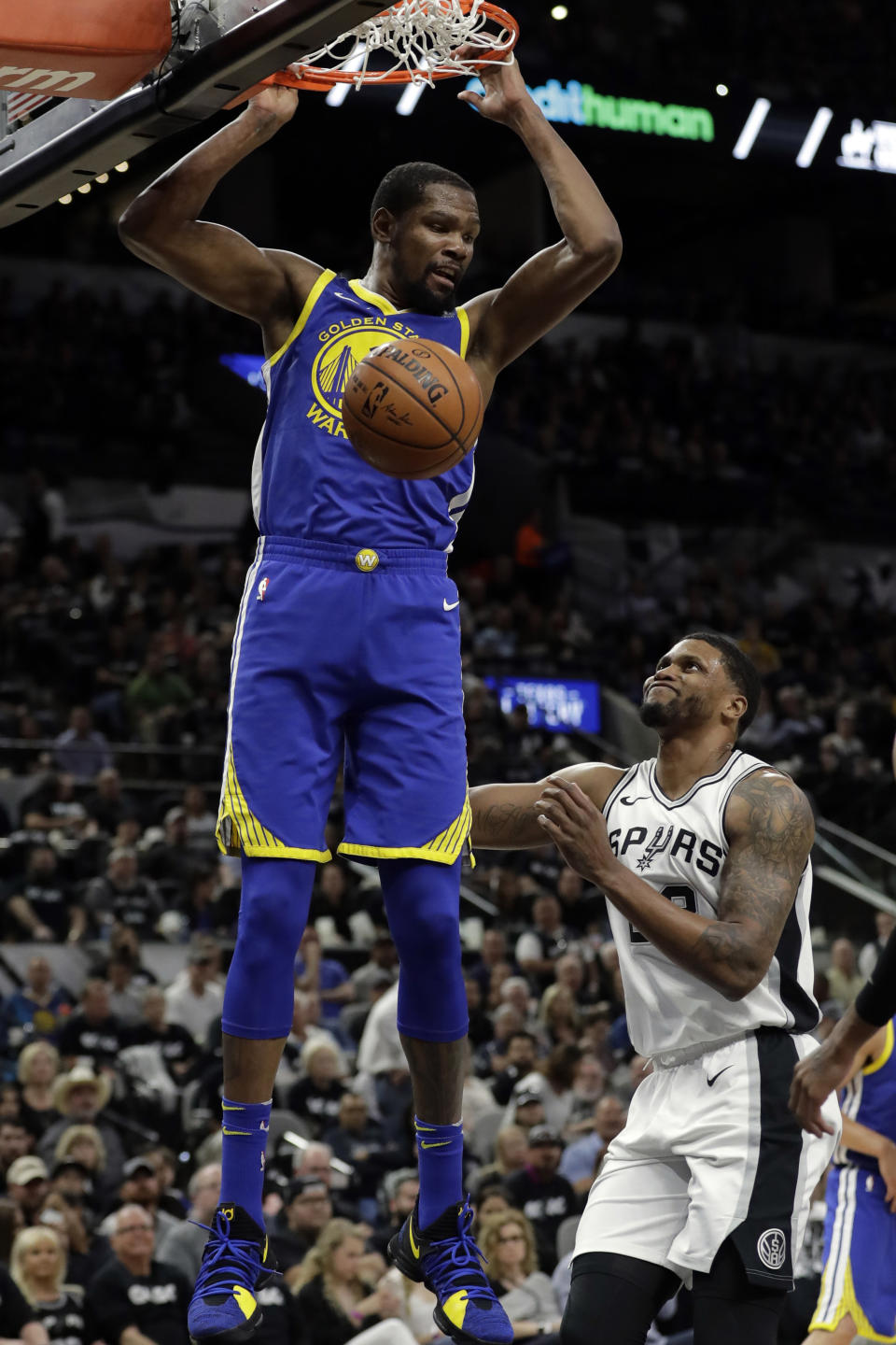 FILE - In this April 19, 2018, file photo, Golden State Warriors forward Kevin Durant dunks as San Antonio Spurs' Rudy Gay (22) watches during the the first half of Game 3 of a first-round NBA basketball playoff series in San Antonio. Just three seasons ago, the Brooklyn Nets were the worst team in the NBA. On Sunday, June 30, 2019, they were the story of the league. They agreed to deals with superstars Kevin Durant and Kyrie Irving as part of a sensational start to free agency, giving the longtime No. 2 team in New York top billing in the Big Apple. (AP Photo/Tony Gutierrez, File)