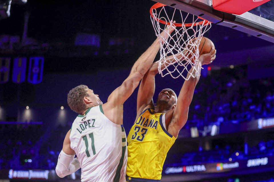 Milwaukee Bucks center Brook Lopez (11) defends while Indiana Pacers center Myles Turner (33) shoots during the second half of a semifinal in the NBA basketball In-Season Tournament, Thursday, Dec. 7, 2023, in Las Vegas. (AP Photo/Ian Maule)