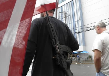 Pro-gun advocates take to the streets outside the University of Texas ahead of a 'mock mass shooting' event where they used cardboard cut-outs rifles, the simulated bangs of bullets on bullhorns and doused fake victims with fake blood, in Austin, Texas, U.S. on December 12, 2015. REUTERS/Jon Herskovitz/File Photo