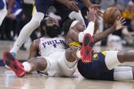 Philadelphia 76ers' James Harden (1) and Indiana Pacers' Buddy Hield (24) battle for the ball during the second half of an NBA basketball game, Monday, March 6, 2023, in Indianapolis. (AP Photo/Darron Cummings)