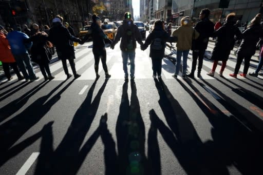 Protestors gather outside the New York Public Library on November 29 as part of a demonstration to demand transformative climate action