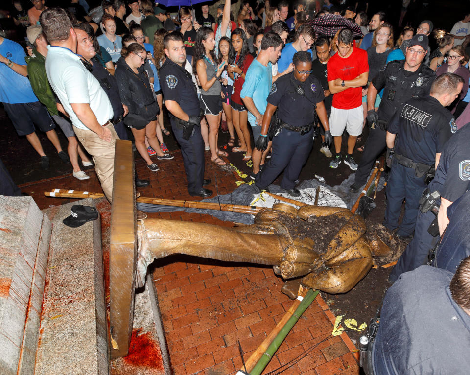 Police and protesters surround the toppled statue of a Confederate soldier known as Silent Sam on the University of North Carolina-Chapel Hill campus after a local demonstration for its removal on Aug. 20, 2018. (Photo: Jonathan Drake / Reuters)