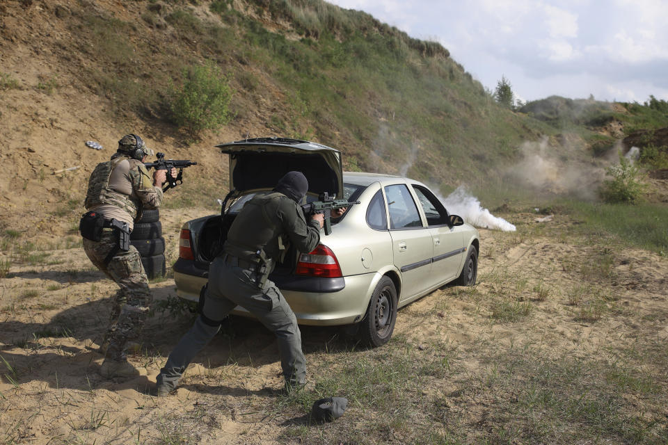 Volunteers from Belarus train at a shooting range near Warsaw, Poland, on Friday, May 20, 2022. The fighters from Belarus are improving their military skills in Poland before deploying to Ukraine, where they plan to join a legion of foreign fighters defending Ukraine against Russian attacks. (AP Photo/Michal Dyjuk)