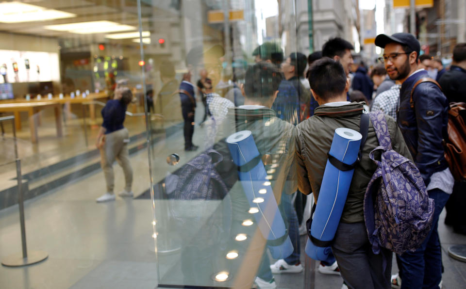 An Apple customer who camped overnight with a roll-up mattress waits outside Australia's flagship store in the minutes leading up to the first sale of the iPhone 7 and Apple Watch Series 2 in Sydney, September 16, 2016. REUTERS/Steven Saphore FOR EDITORIAL USE ONLY. NO RESALES. NO ARCHIVES.