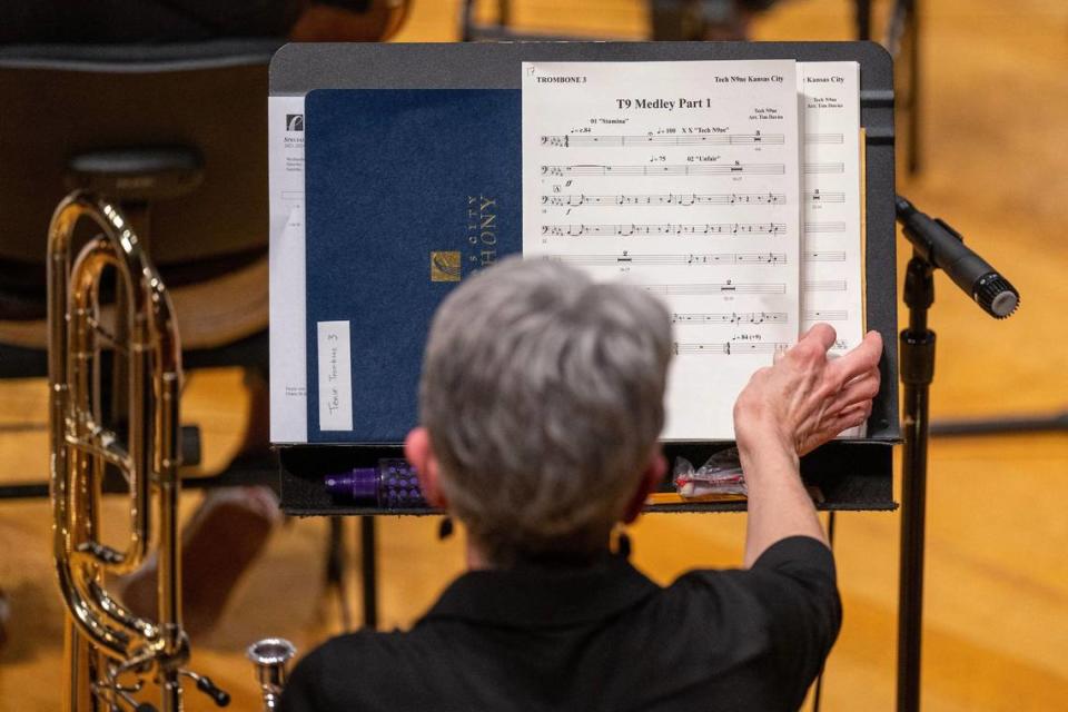 A trombone player from the Kansas City Symphony checks their sheet music before rehearsing with rapper Tech N9ne for the Saturday performance.