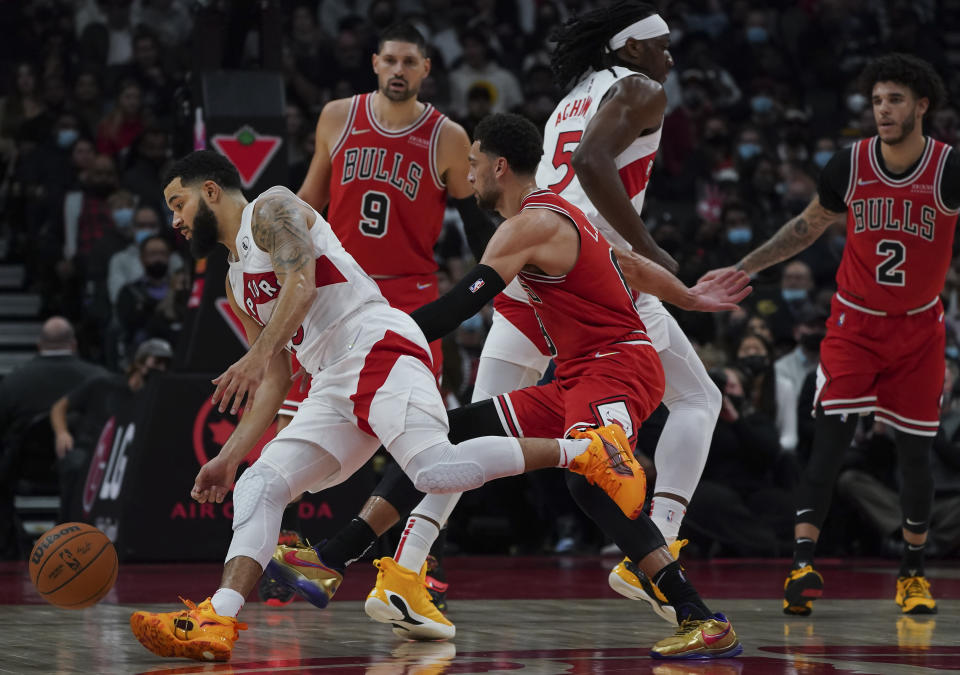 Toronto Raptors guard Fred VanVleet (23) drives the ball past Chicago Bulls guard Zach LaVine (8) during first-half NBA basketball game action in Toronto, Monday, Oct. 25, 2021. (Nathan Denette/The Canadian Press via AP)