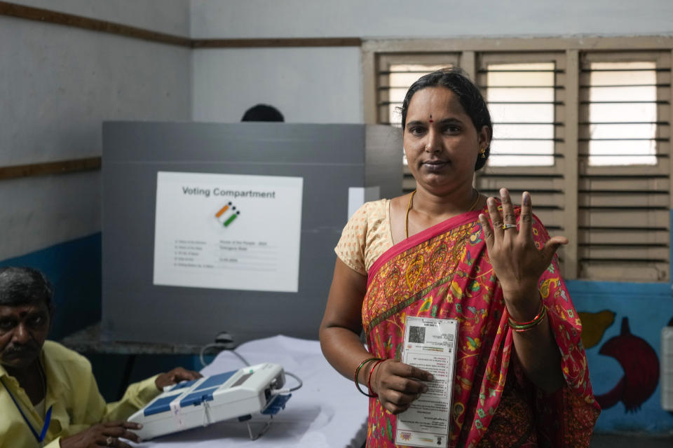 A woman shows the indelible ink mark on her index finger after casting vote in a polling station during the fourth phase of general election in Hyderabad, India, Monday, May 13, 2024. (AP Photo/Mahesh Kumar A.)