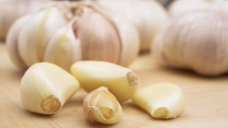 cloves of garlic on board