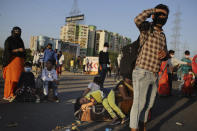 In this Saturday, March 28, 2020, file photo, a young girl lies on a luggage as she along with her family awaits transportation to her village following a lockdown amid concern over spread of coronavirus in New Delhi, India. Over the past week, India’s migrant workers - the mainstay of the country’s labor force - spilled out of big cities that have been shuttered due to the coronavirus and returned to their villages, sparking fears that the virus could spread to the countryside. It was an exodus unlike anything seen in India since the 1947 Partition, when British colothe subcontinent, with the 21-day lockdown leaving millions of migrants with no choice but to return to their home villages. (AP Photo/Altaf Qadri)