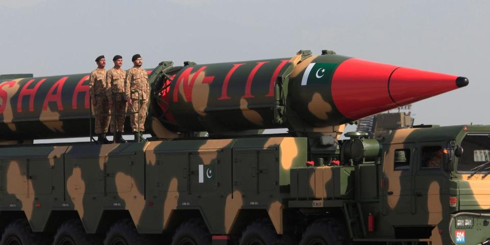 Pakistani military personnel stand beside a Shaheen III surface-to-surface ballistic missile during Pakistan Day military parade in Islamabad, Pakistan, in March 2017.