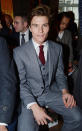 <b>Oliver Cheshire</b><br><br>Pixie Lott's boyfriend looked dapper in a grey suit with red tie at the Richard James show.