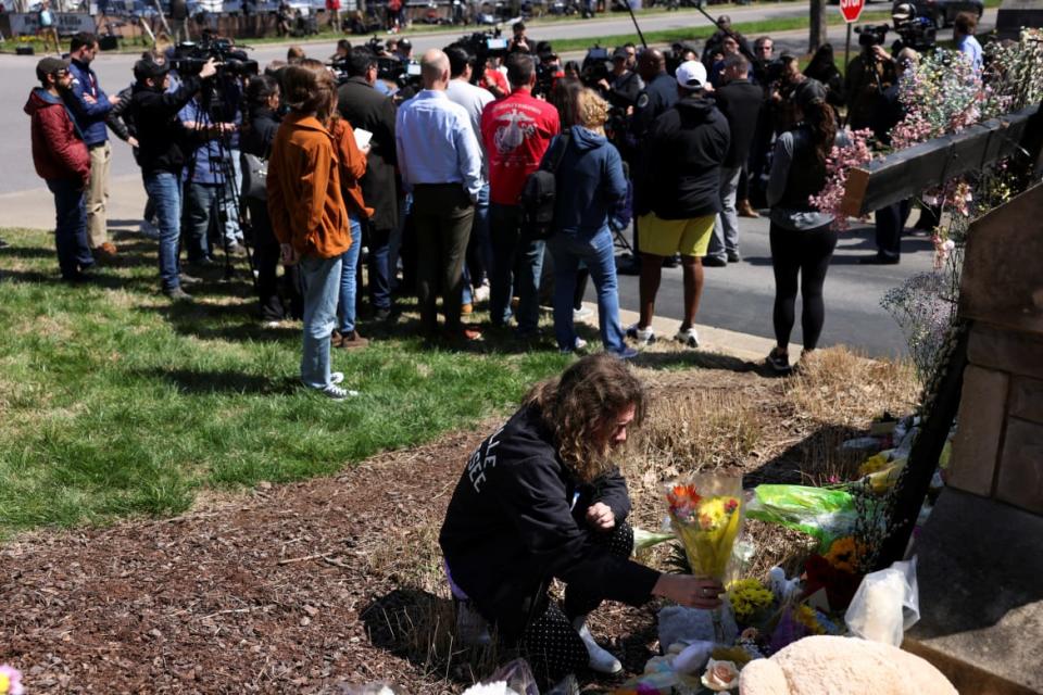 <div class="inline-image__caption"><p>Reece Bittner, a student at Belmont University, places flowers at a memorial as Nashville Chief of Police John Drake speaks at a news conference at the school entrance after a deadly shooting at the Covenant School in Nashville, Tennessee, U.S. March 28, 2023.</p></div> <div class="inline-image__credit">REUTERS/Austin Anthony</div>