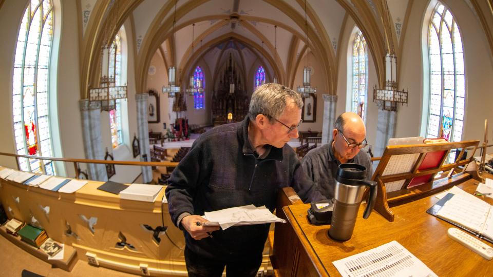 Tom Engman, left, and Steven Werner, go over details before proceeding to fine tune a pipe, Friday, March 31, 2023, on the newly renovated Austin Organ at Holy Name Catholic Church, in Sheboygan, Wis.