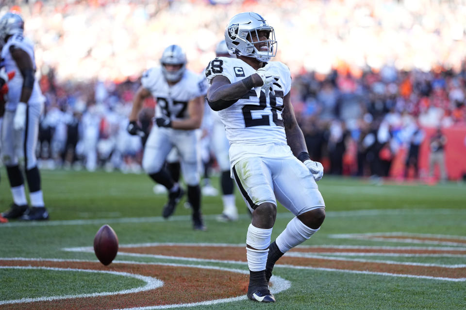 Las Vegas Raiders running back Josh Jacobs (28) runs in a touchdown against the Denver Broncos during the second half of an NFL football game, Sunday, Oct. 17, 2021, in Denver. (AP Photo/Jack Dempsey)