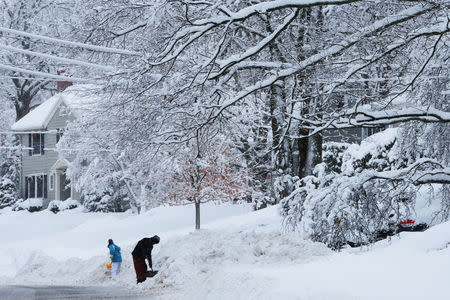 Residents dig out following a winter snow storm in the Boston suburb of Wakefield, Massachusetts, U.S. February 13, 2017. REUTERS/Brian Snyder