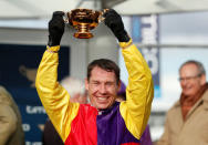 Horse Racing - Cheltenham Festival - Cheltenham Racecourse, Cheltenham, Britain - March 16, 2018 Richard Johnson celebrates with the trophy after riding Native River to victory in the 15.30 Timico Cheltenham Gold Cup Chase Action Images via Reuters/Andrew Boyers