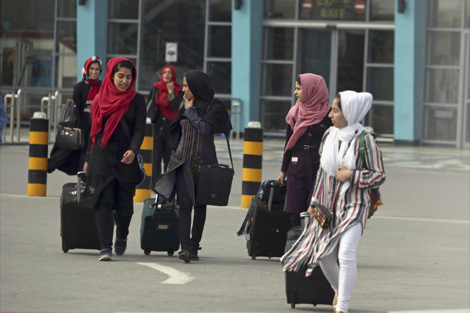 FILE - Members of a female robotics team arrive from Herat province to receive visas from the U.S. embassy, at the Hamid Karzai International Airport in Kabul, Afghanistan, July 13, 2017. Afghanistan's Taliban rulers refused to allow dozens of women to board several flights, including some overseas, because they were traveling without a male guardian, two Afghan airline officials said Saturday, March 26, 2022. (AP Photo/Rahmat Gul, File)