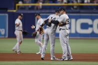 New York Yankees third baseman Marwin Gonzalez (14) embraces first baseman Anthony Rizzo (48) after the Yankees defeated the Tampa Bay Rays in a baseball game Friday, May 27, 2022, in St. Petersburg, Fla. (AP Photo/Scott Audette)