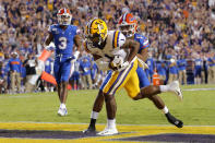 LSU wide receiver Ja'Marr Chase (1) pulls in a touchdown reception against Florida defensive back CJ Henderson (1) in the first half of an NCAA college football game in Baton Rouge, La., Saturday, Oct. 12, 2019. (AP Photo/Gerald Herbert)