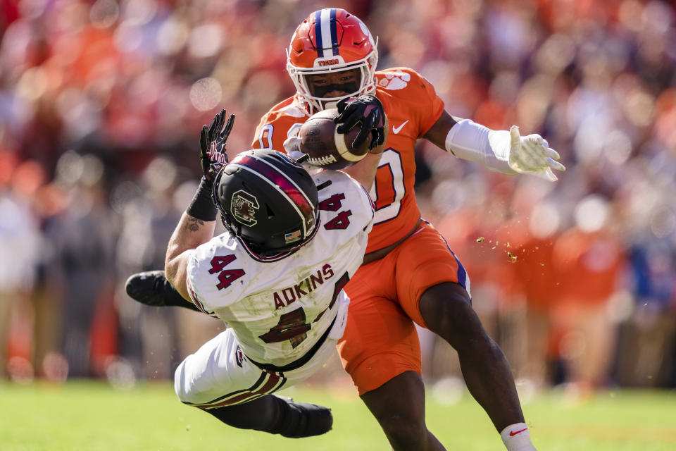 South Carolina tight end Nate Adkins (44) makes a catch while covered by Clemson linebacker Barrett Carter (0) in the first half of an NCAA college football game on Saturday, Nov. 26, 2022, in Clemson, S.C. (AP Photo/Jacob Kupferman)