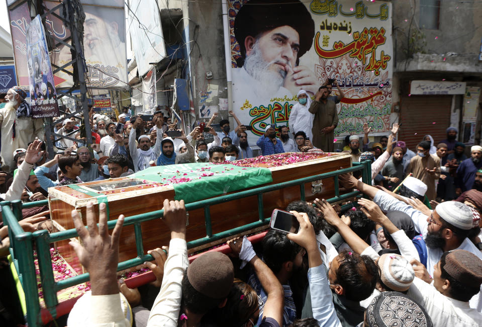 Supporters of Tehreek-e-Labiak Pakistan, a banned Islamist party, carry a casket of their colleague, who was killed in the Sunday's clash with police, for a funeral prayer, in Lahore, Pakistan, Monday, April 19, 2021. The outlawed Pakistani Islamist political group freed 11 policemen almost a day after taking them hostage in the eastern city of Lahore amid violent clashes with security forces, the country's interior minister said Monday. (AP Photo/K.M. Chaudary)