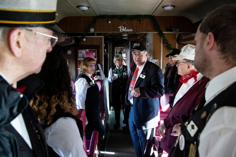 Dean Pyers, executive director of the Steam Railroading Institute, center, holds a car host meeting before the North Pole Express takes off in Owosso on Friday, Nov. 24, 2023.