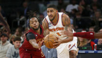 Cleveland Cavaliers guard Darius Garland, left, defends New York Knicks forward Obi Toppin (1) during the second half of an NBA basketball game, Sunday, Dec. 4, 2022, in New York. The Knicks won 92-81. (AP Photo/John Munson)