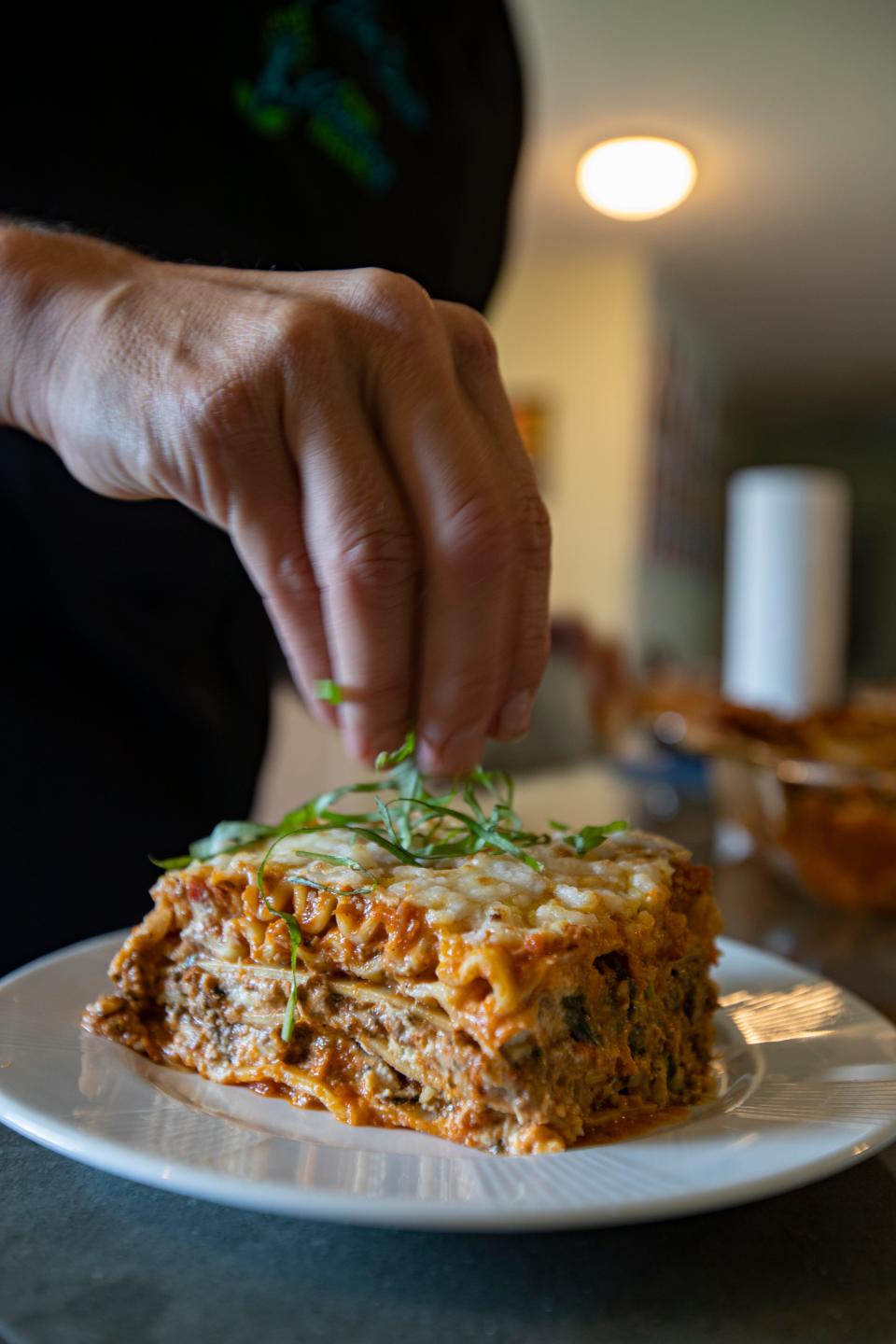 Chef Lisa Brown, owner of Cape Coral-based Free Flowing Health, garnishes a serving of lasagna with zucchini, sun-dried tomato and basil pesto, and cashew ricotta.