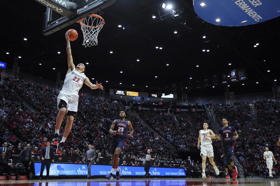 San Diego State guard Malachi Flynn (22) goes to the basket as Fresno State guard Anthony Holland (25) looks on during the second half of an NCAA college basketball game Wednesday, Jan. 1, 2020, in San Diego. San Diego won 61-52. (AP Photo/Orlando Ramirez)