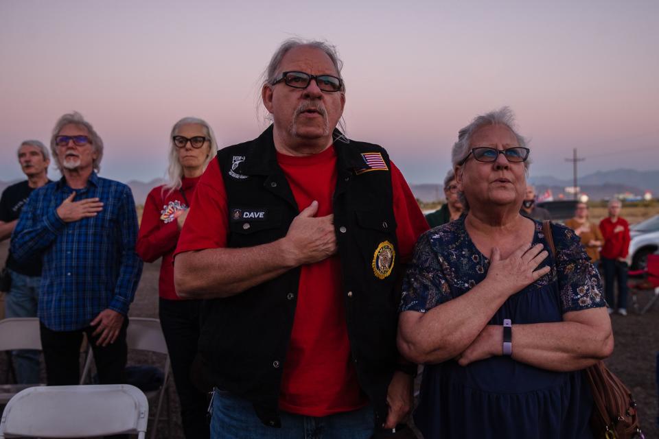 Trump supporters sing a patriotic song as they gather to watch the last presidential debate outside the Great American Pizza and Subs restaurant in Golden Valley, Arizona on October 22, 2020. (Photo by ARIANA DREHSLER / AFP) (Photo by ARIANA DREHSLER/AFP via Getty Images)